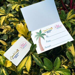 A card sitting on top of some green plants.