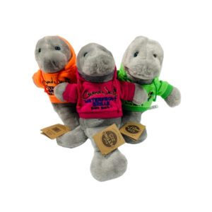 Three stuffed animals wearing jackets and sitting on a table.