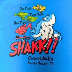 A blue shirt with a shark and fish design.