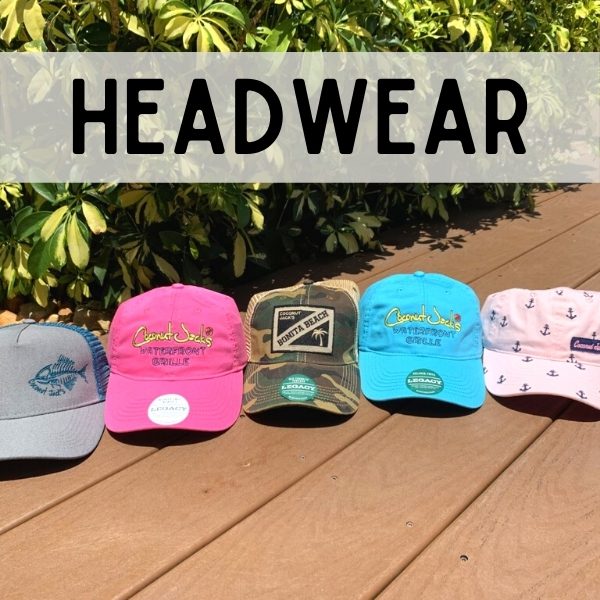 A group of hats sitting on top of a wooden deck.