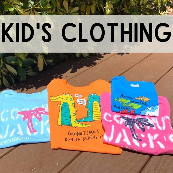 A group of kids clothing sitting on top of a wooden deck.