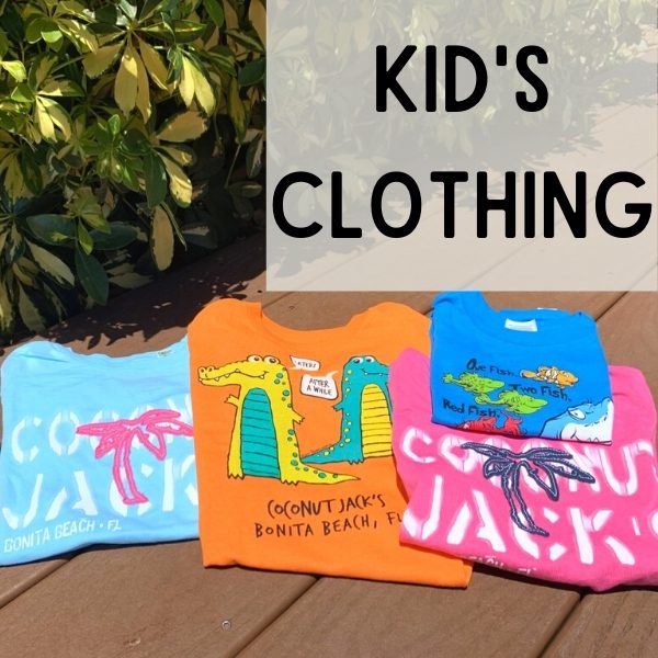 A group of kids clothing sitting on top of a wooden deck.