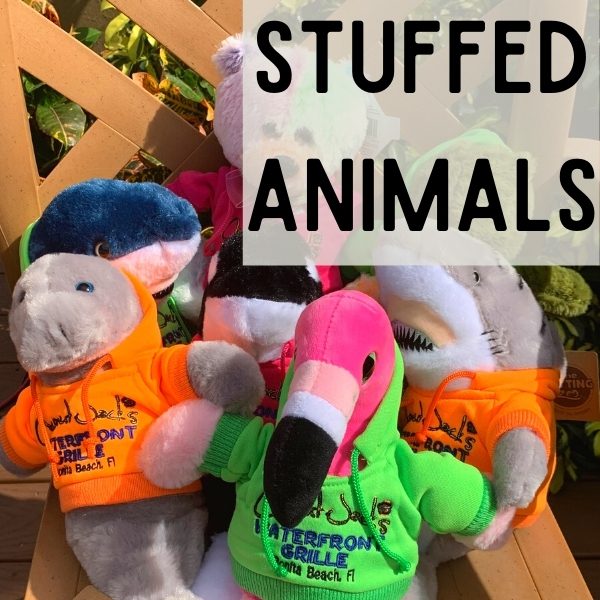 Stuffed animals are sitting in a chair.