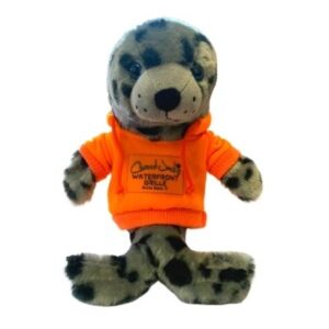 A stuffed animal wearing an orange shirt.