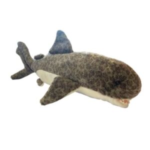 A stuffed shark laying on its side.