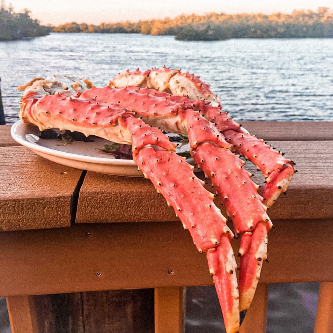 A plate of crab on the edge of a dock.