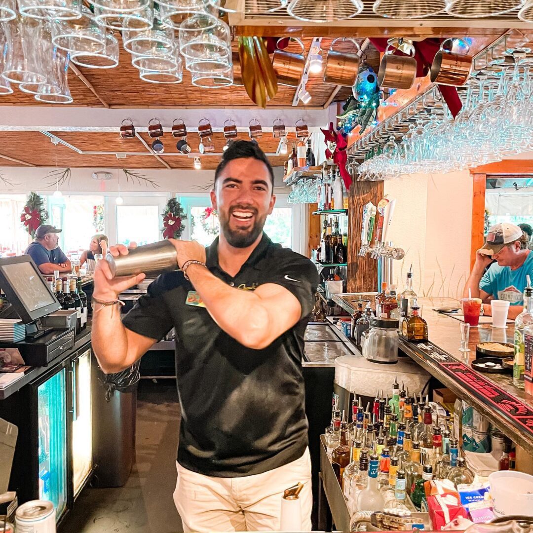 A man holding a drink in his hand.