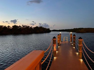 A dock with lights on the end of it