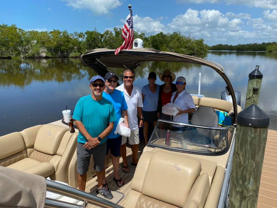 A group of people on a boat in the water.