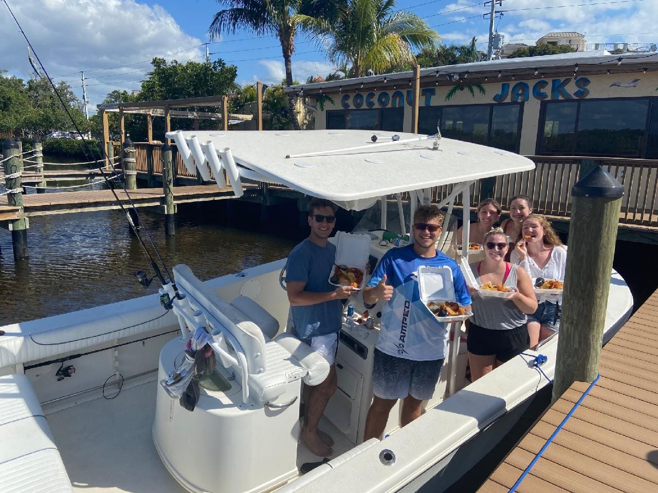 A group of people standing on top of a boat.