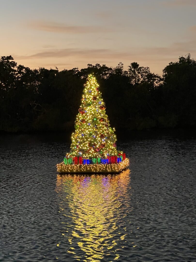 A boat with a christmas tree on top of it.
