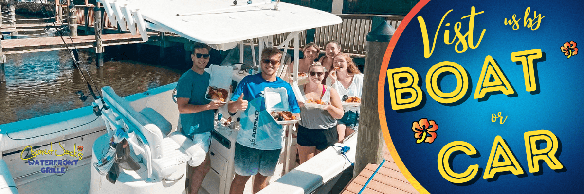 A group of people standing around on the boat.