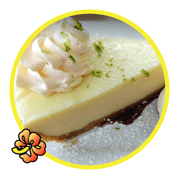A piece of cheesecake with whipped cream on top.