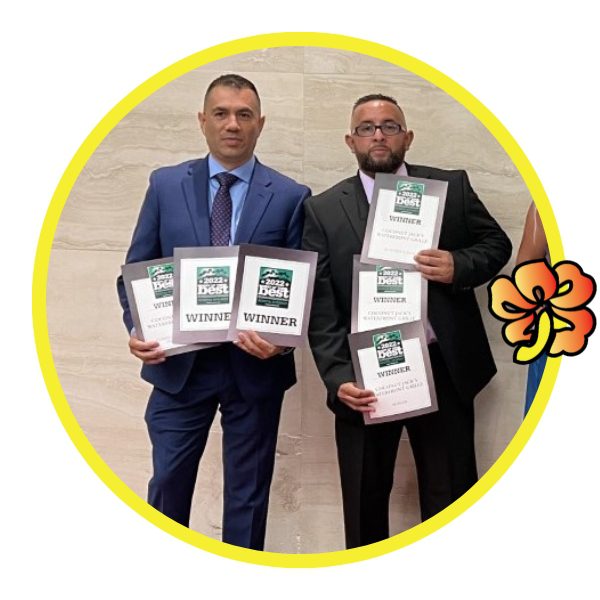 Two men holding up their awards in a circle.