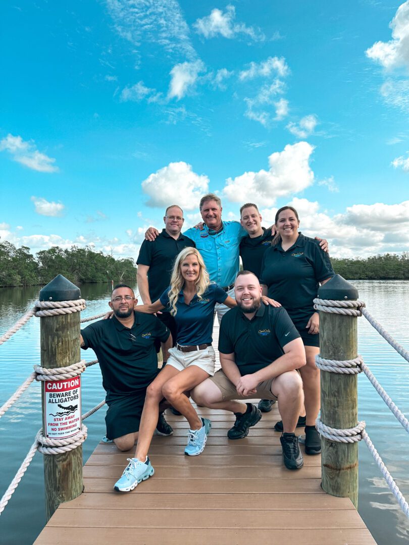 A group of people standing on top of a dock.