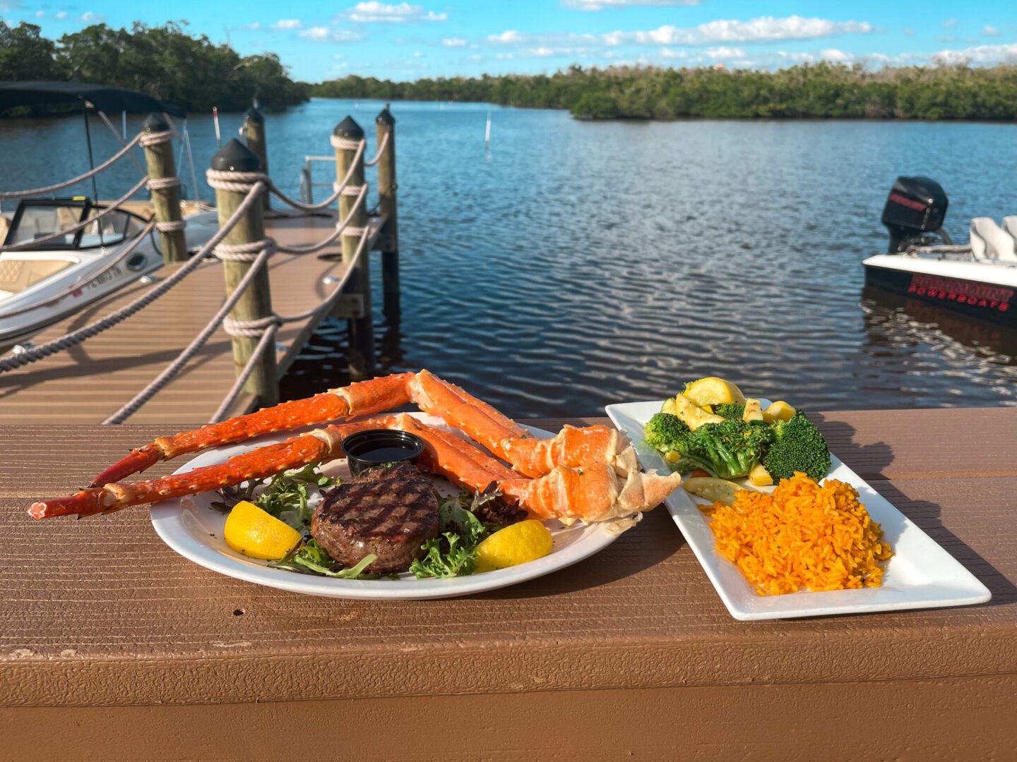 A plate of food on the edge of a dock.