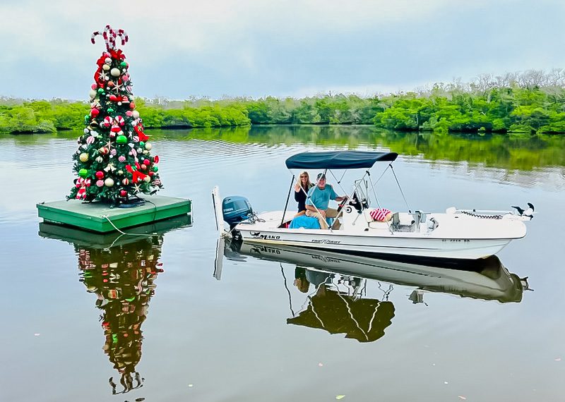 A boat with two people on it in the water.