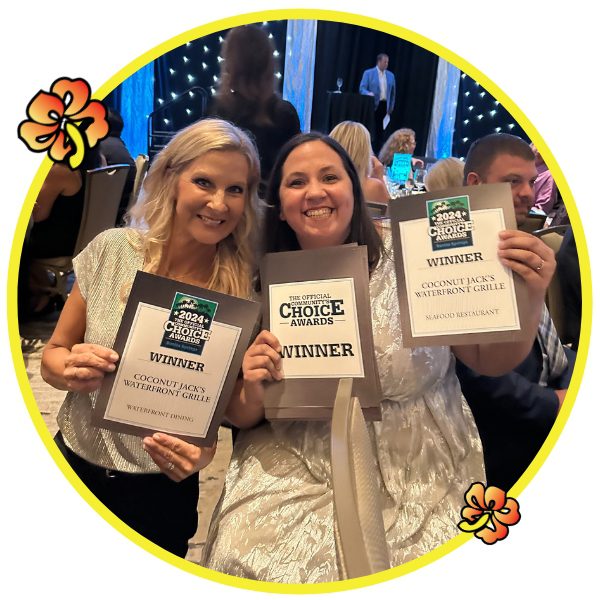 Two women holding up their awards in a circle.