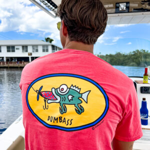 A man wearing a pink shirt with a fish on it.