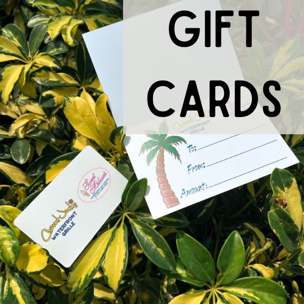A bunch of leaves with some gift cards