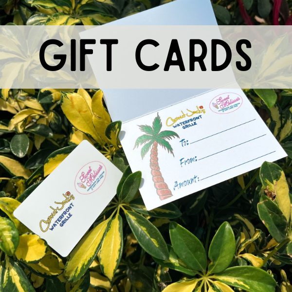 A bunch of different gift cards sitting on some leaves