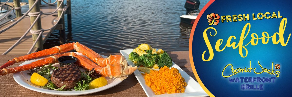 A plate of food on the table near water.